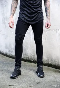 Detailed view of mens black skinny jeans with elastic slim fit and urban streetwear design style