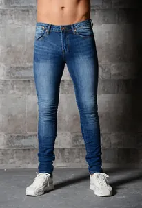 Close-up of men's slim fit blue skinny jeans featuring faded denim wash detail