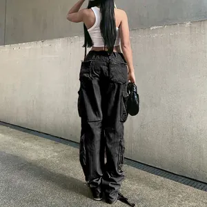 Detailed back view of these women's black multi-pocket cargo jeans in street style.