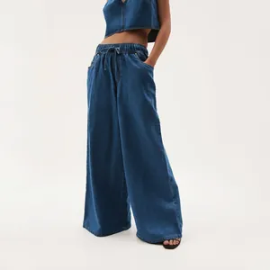 Detailed view of dark blue washed wide-leg denim pants for women with elastic waist.