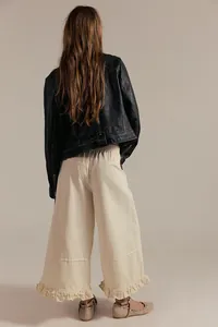 Detailed back view of women's off-white wide-leg cropped jeans with ruffled hem