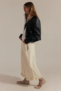 Full side profile of cream wide-leg cropped jeans with feminine ruffled hem design