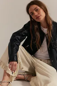 Women's wide-leg cropped denim jeans featuring a stylish ruffle hem and loose fit