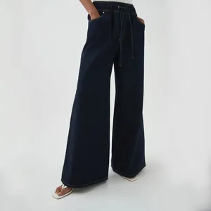 Detailed view of dark blue wide-leg denim pants with elastic drawstring waist for women.