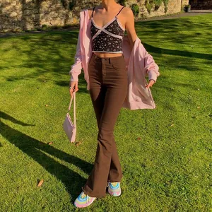 Brown high-waisted slim flare jeans with frayed hem shown in an outdoor lifestyle setting