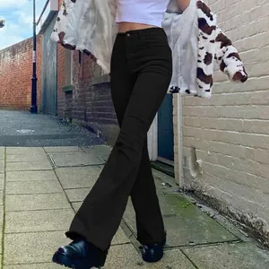 Full view of black high-waisted slim-fit flared jeans in a street style setting