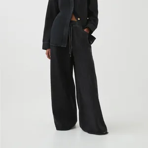 Detail view of women's vintage washed low waist wide-leg denim jeans in black