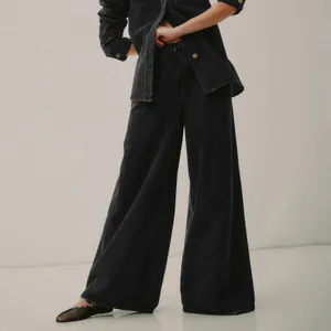 Close-up of vintage black washed denim wide-leg pants with elastic waist detail