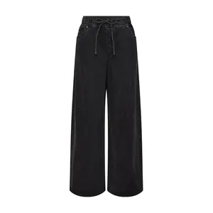 Detail of black washed wide-leg denim pants featuring drawstring elastic waistband