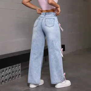 Trendy Y2K street style light wash wide-leg denim jeans featuring cute pink side bows