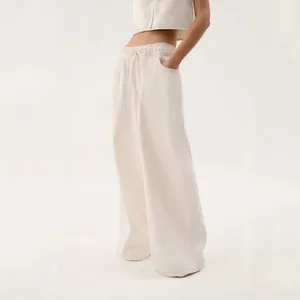 Detail shot of off-white vintage low-waist wide-leg denim jeans for women outfit.