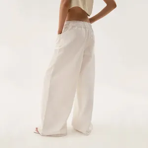 Detailed back view of vintage cream wide-leg denim jeans with comfortable elastic waist