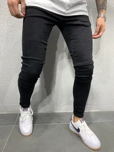 Men's stylish black skinny jeans in stretch denim fabric, showing slim fit leg silhouette