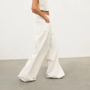 Side view of retro low-waist wide-leg denim jeans in cream white wash finish