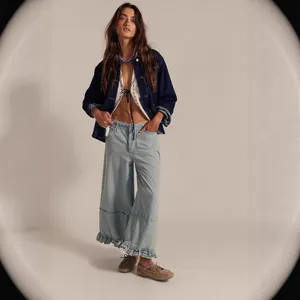 Women's light blue wide leg cropped denim pants featuring a stylish ruffled hem and relaxed fit