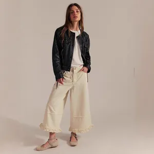 Women's off-white wide-leg cropped jeans with ruffled hem detail.