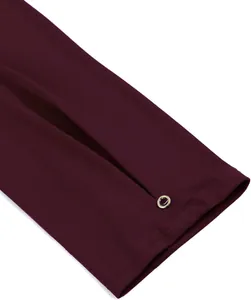 Detail of burgundy women's 3/4 sleeve tunic showing cuff slit with gold eyelet accent