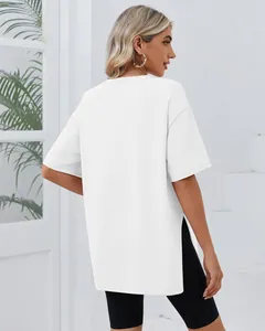 Back view of minimalist white oversized crew neck T-shirt featuring side split hem detail