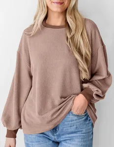 Gedetailleerd overzicht van een mauve getextureerde wafelgebreide losse trui met mouwen