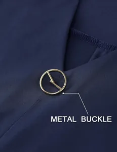 Detailed macro shot of the golden metal buckle on a navy blue V-neck women's tunic