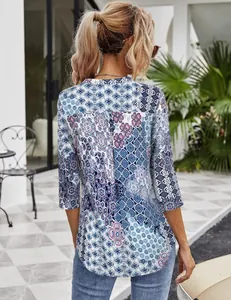 Close-up detailed back view of a bohemian style women's blouse with blue floral mosaic pattern