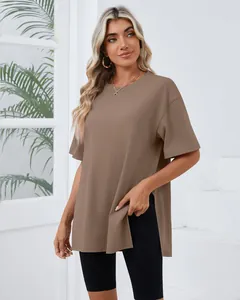 Woman wearing brown loose short sleeve T-shirt with side slit and round neck