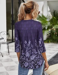 Back view of women's purple 3/4 sleeve blouse featuring elegant floral print pattern
