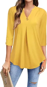 Detailed view of yellow V-neck tunic top featuring 3/4 sleeves and front pleat detail