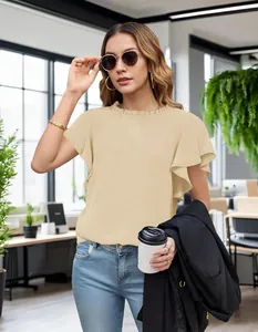Detailed view of an elegant beige ruffled sleeve blouse worn in a modern office
