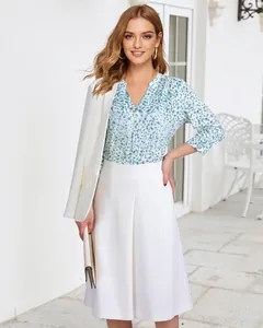 Detailed styling of floral 3/4 sleeve V-neck blouse paired with a white chic blazer