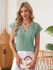 Detail of women's sage green V-neck top featuring intricate shoulder lace embroidery