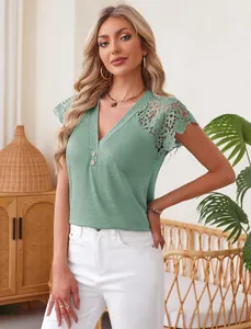Detailed shot of a green V-neck top featuring delicate lace shoulder trim and buttons