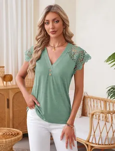 Sage green V-neck top with intricate lace shoulder detailing in a home setting.