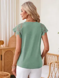 Detail view of a women's sage green top with intricate lace shoulder trimming and loose fit.