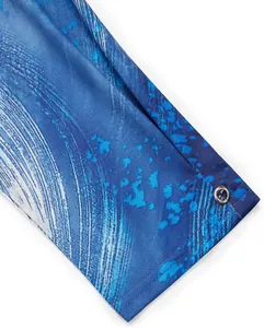 Detailed macro view of blue ink splash patterned fabric on a women's casual tunic shirt
