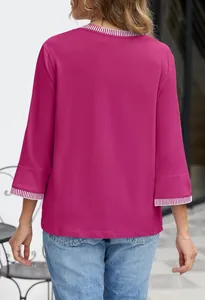 Back view of magenta knit top with striped ribbed cuffs and collar detailing