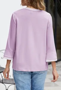 Back view of a lavender knit top featuring stylish striped ribbed neck and sleeve cuffs.