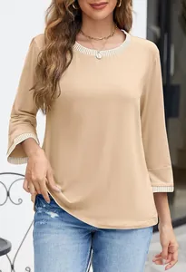 Close-up of beige knit top featuring striped ribbed crew neck and cuff detailing.