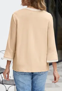 Detailed back view of beige casual knit top with contrast striped ribbing on collar and cuffs