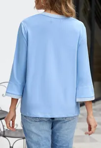 Back view of light blue knitted top with striped ribbed cuffs and round neck design.