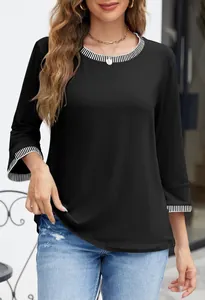 Detailed view of women's black knit top with contrast striped rib neckline and cuffs.