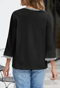 Back view of a black women's top with contrast striped ribbed neckline and cuffs