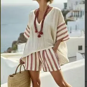 Full view of casual V-neck top and red striped shorts set in a summer resort setting