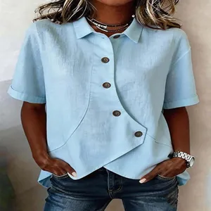 Detail view of light blue irregular button shirt showing linen fabric texture and cut