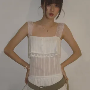 Detailed view of a white square neck camisole with delicate lace straps and sheer stripes