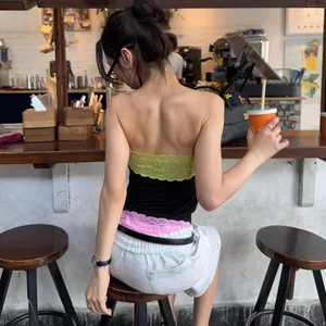Back view of a chic color-block lace tube top worn in a trendy cafe setting.