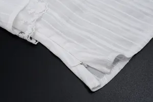 Detail of white sheer camisole featuring side invisible zipper and delicate lace trim