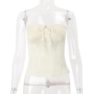 Detailed front view of a cream smocked tube top featuring an elegant ribbon bow