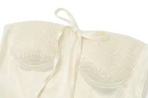 Detailed view of cream satin corset tube top with pleated sweetheart neckline and tie front