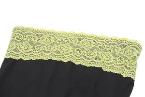 Close-up of black tube top featuring vibrant yellow lace trim for a street style look.